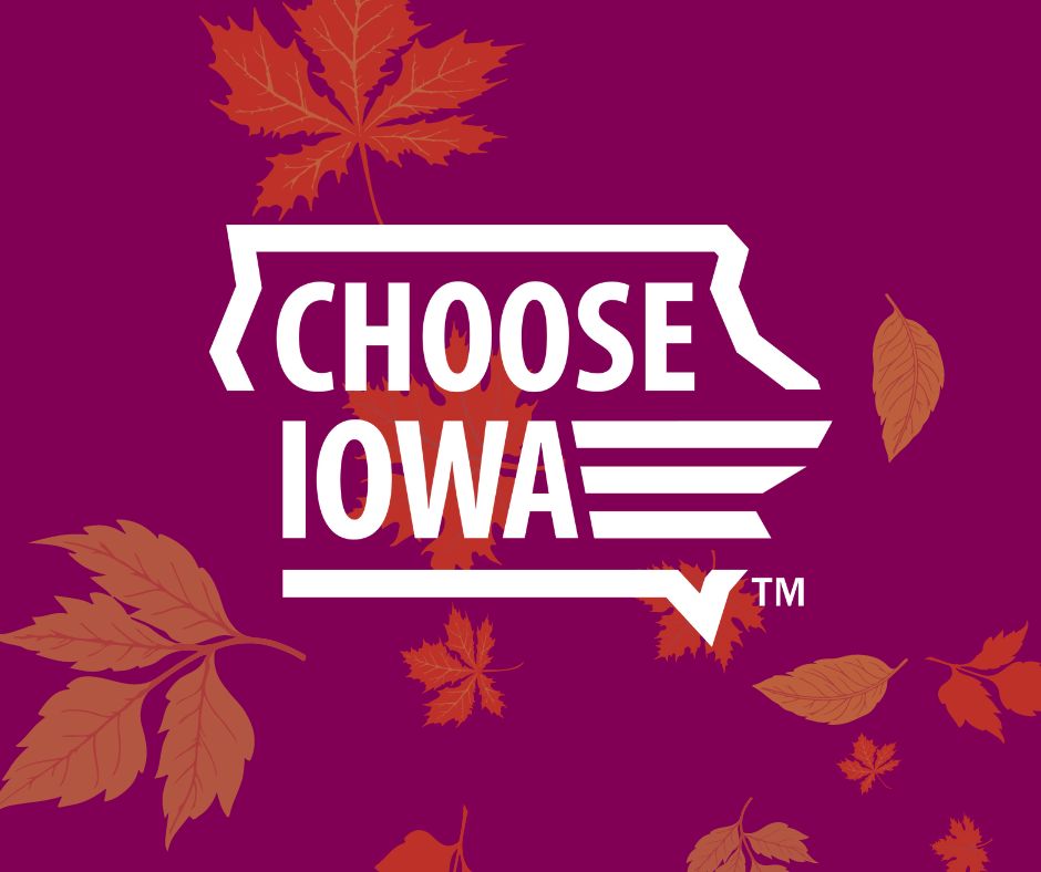 A White Choose Iowa logo sits in front of falling leaves in shades of red and purple