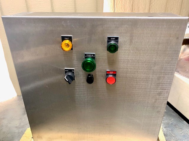 A metal pasteurizer has five buttons in the center.